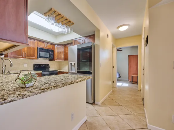 a view of a kitchen with a sink and a refrigerator