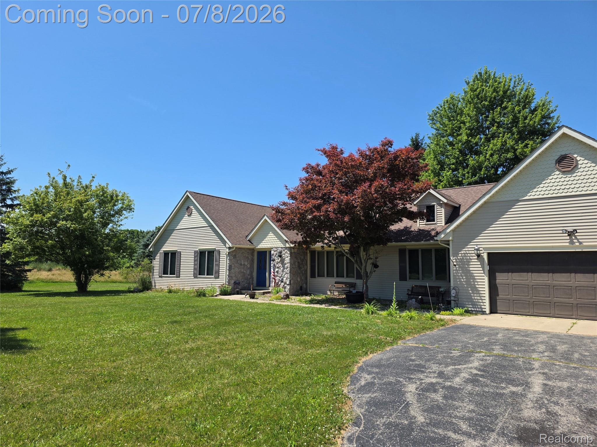 3581 North Burkhart Road Howell, MI 48855 - Photo 12 of 15 Ranch-style residence featuring a two-car attached garage with a panel door