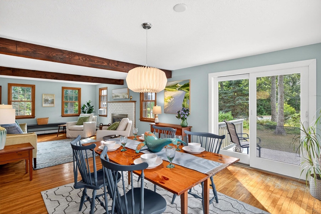 12 Tracy Road Barnstable, MA 02635 - Photo 15 of 42 a living room with fireplace a table and a large window