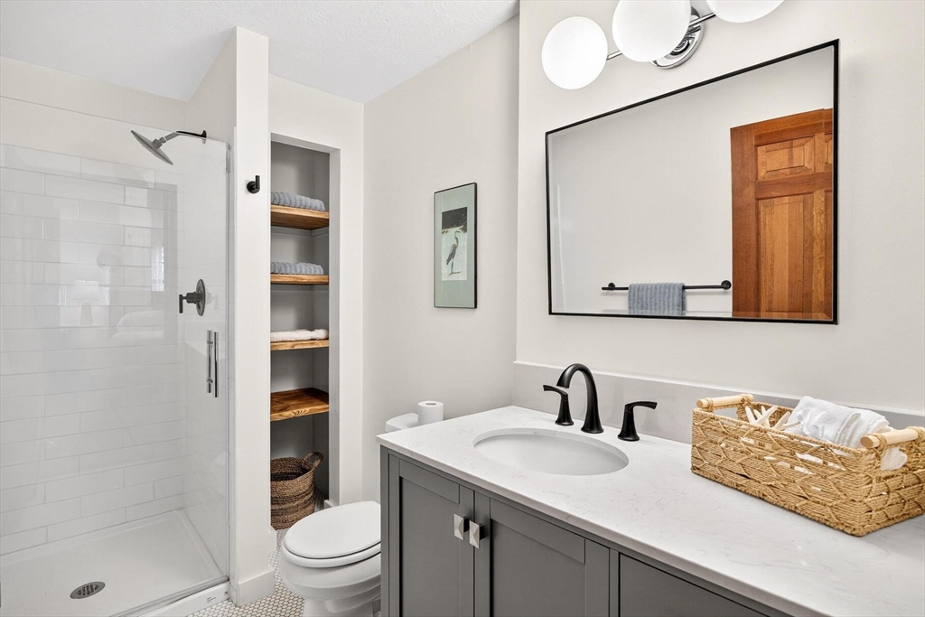 12 Tracy Road Barnstable, MA 02635 - Photo 21 of 42 a bathroom with a sink a toilet and shower