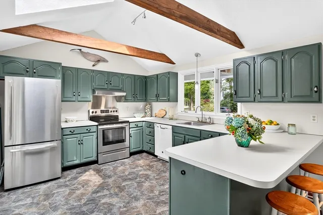 a kitchen with a sink cabinets and stainless steel appliances