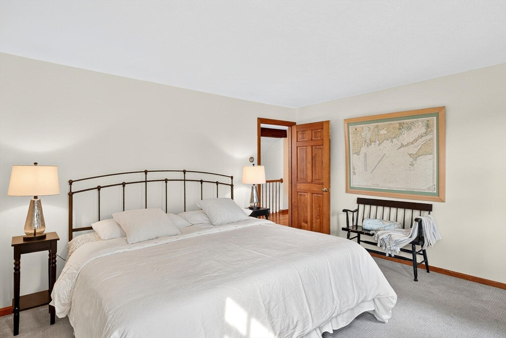 12 Tracy Road Barnstable, MA 02635 - Photo 36 of 42 a large bed sitting in a bedroom next to a window