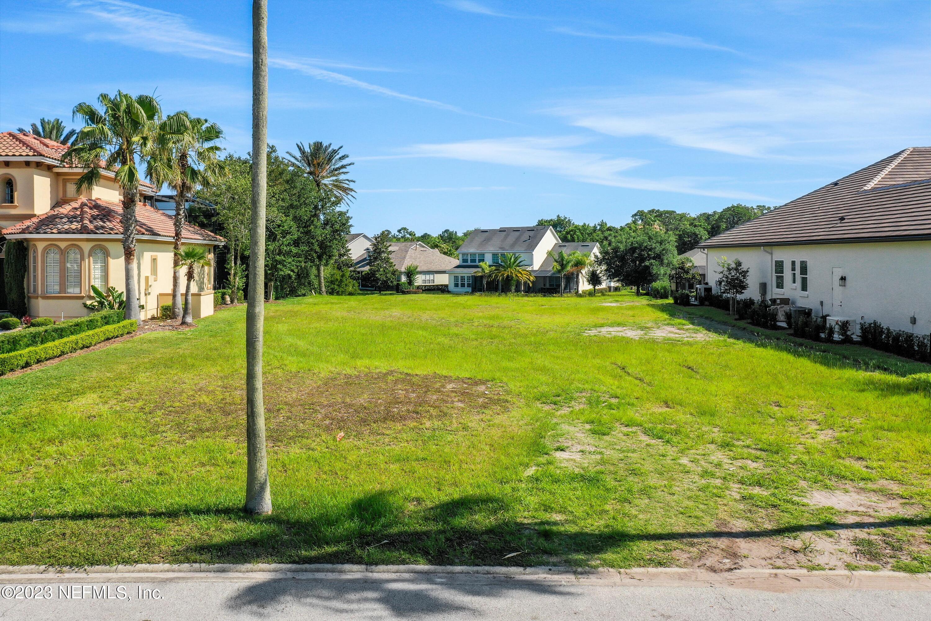 735 Promenade Pointe Drive St. Augustine, FL 32095 - Photo 9 of 22 a view of a garden with a building in the background