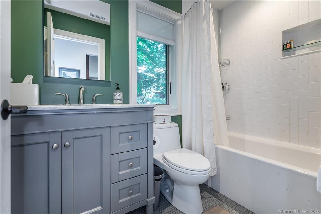 8 Cedar Point Drive Sherman, CT 06784 - Photo 14 of 30 a bathroom with a toilet sink and mirror with bathtub