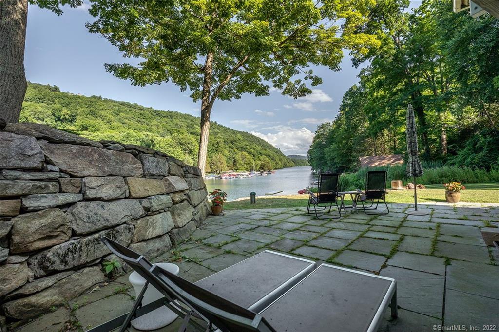 8 Cedar Point Drive Sherman, CT 06784 - Photo 26 of 30 a backyard of a house with table and chairs