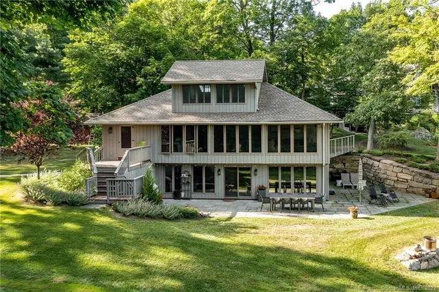 a front view of a house with a yard table and chairs