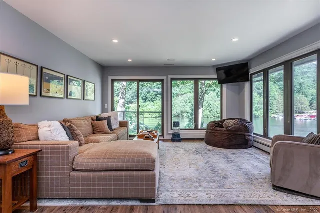 a living room with furniture and large windows
