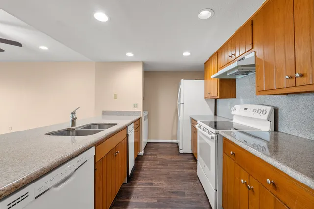 a kitchen with a sink stove and cabinets