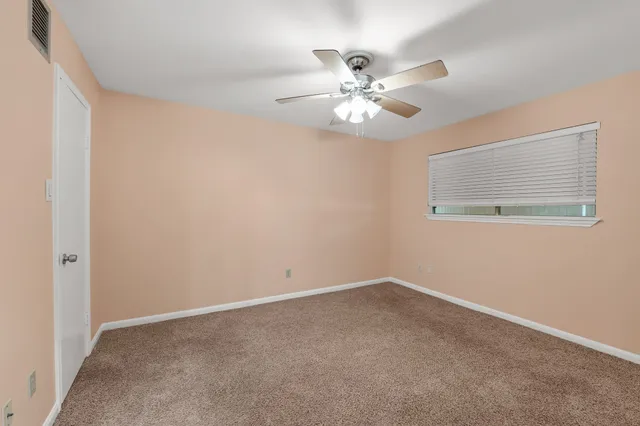 a view of an empty room with a fan