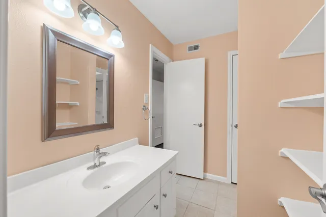a bathroom with a sink mirror and vanity