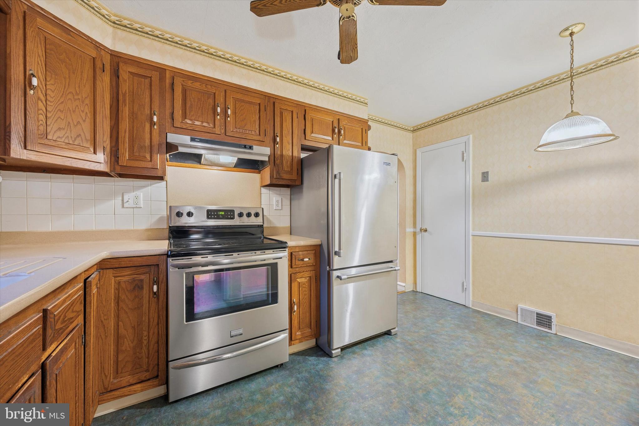 422 West Moreland Avenue Hatboro, PA 19040 - Photo 5 of 17 a kitchen with stainless steel appliances a stove a refrigerator and cabinets
