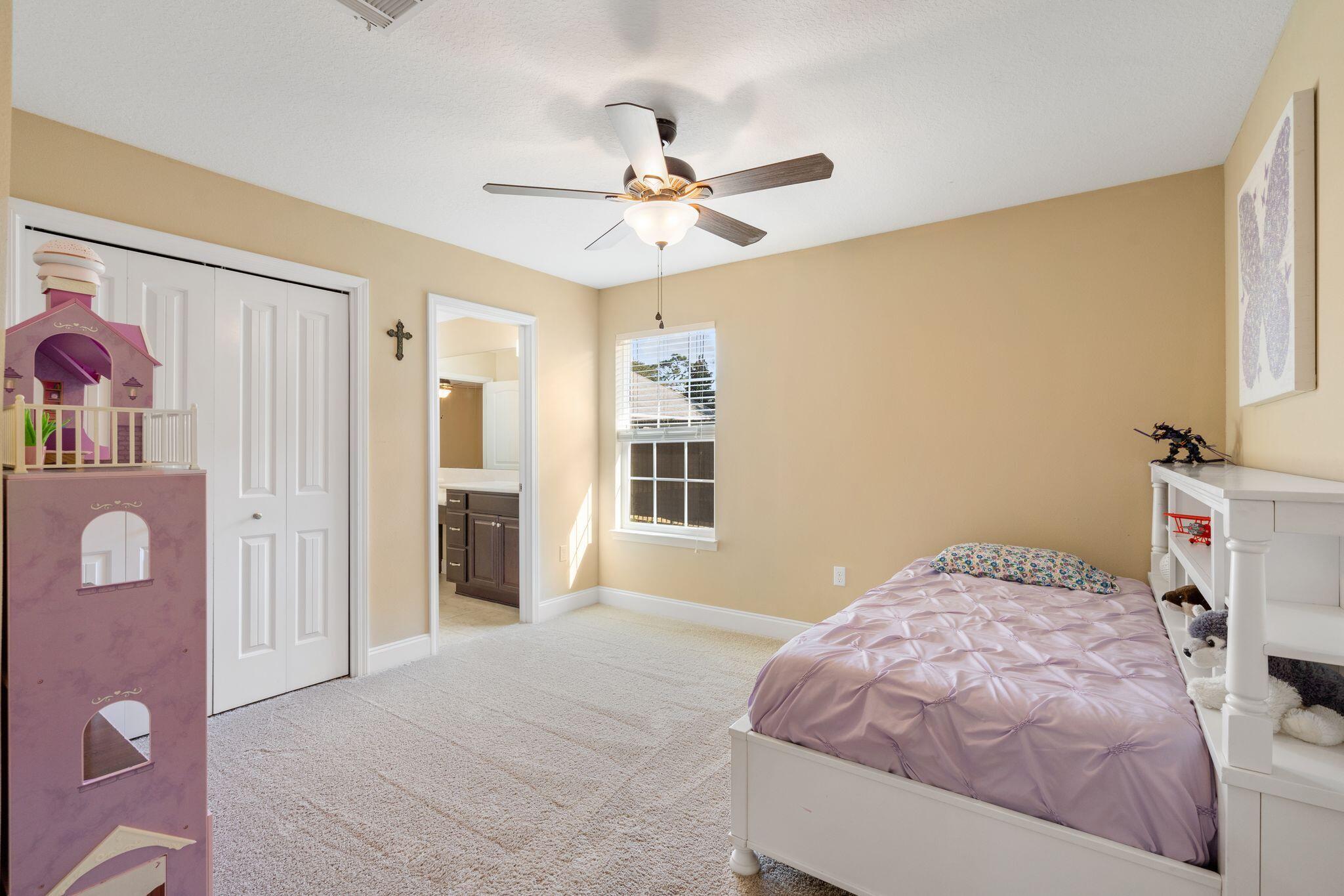 2933 Chancel Avenue Crestview, FL 32539 - Photo 32 of 44 a bedroom with a bed and a chandelier