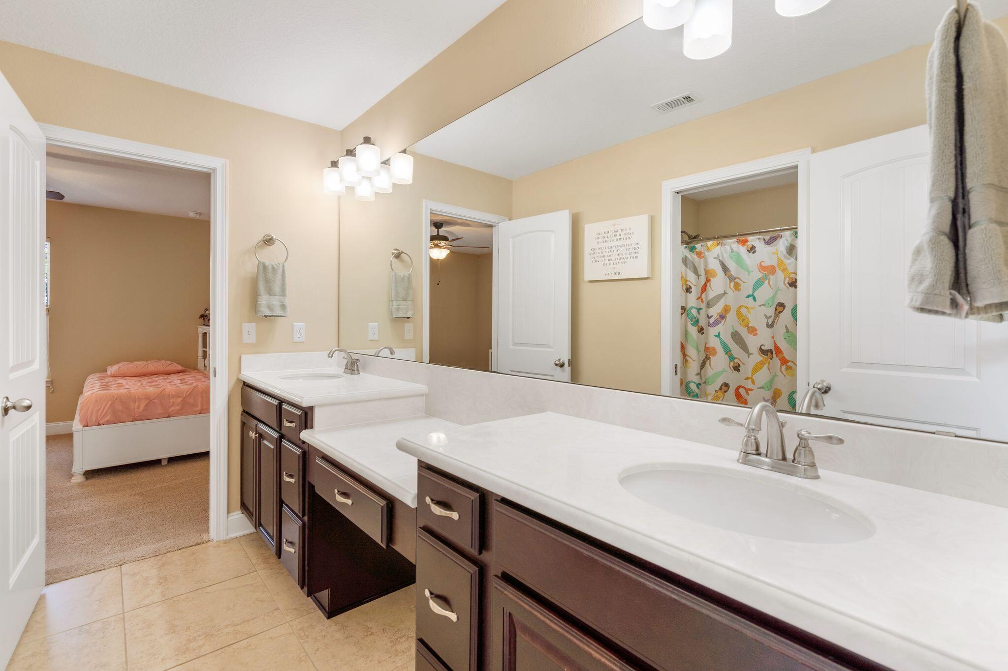 2933 Chancel Avenue Crestview, FL 32539 - Photo 34 of 44 a bathroom with a sink double vanity and a mirror