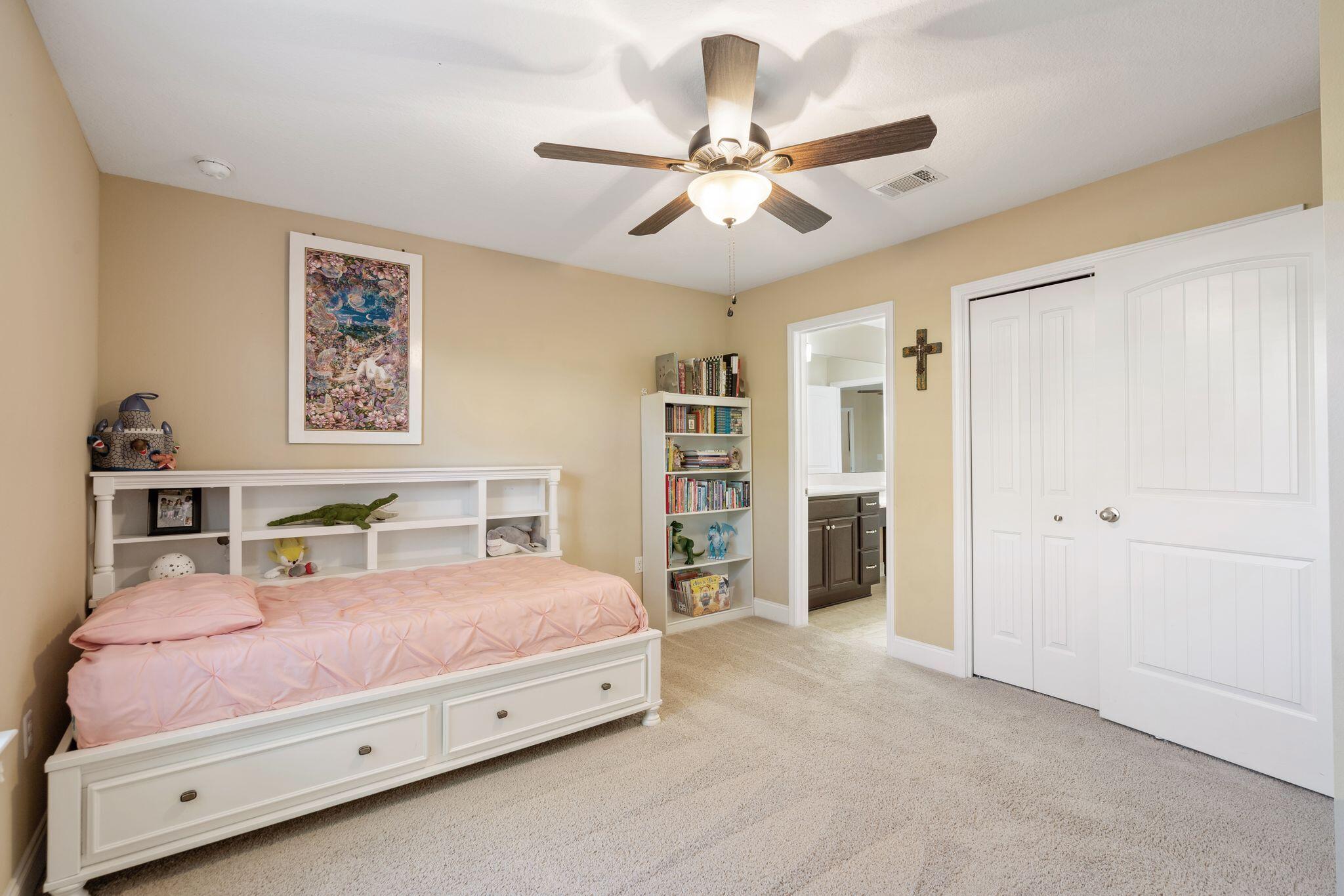 2933 Chancel Avenue Crestview, FL 32539 - Photo 38 of 44 a bedroom with a bed and a chandelier