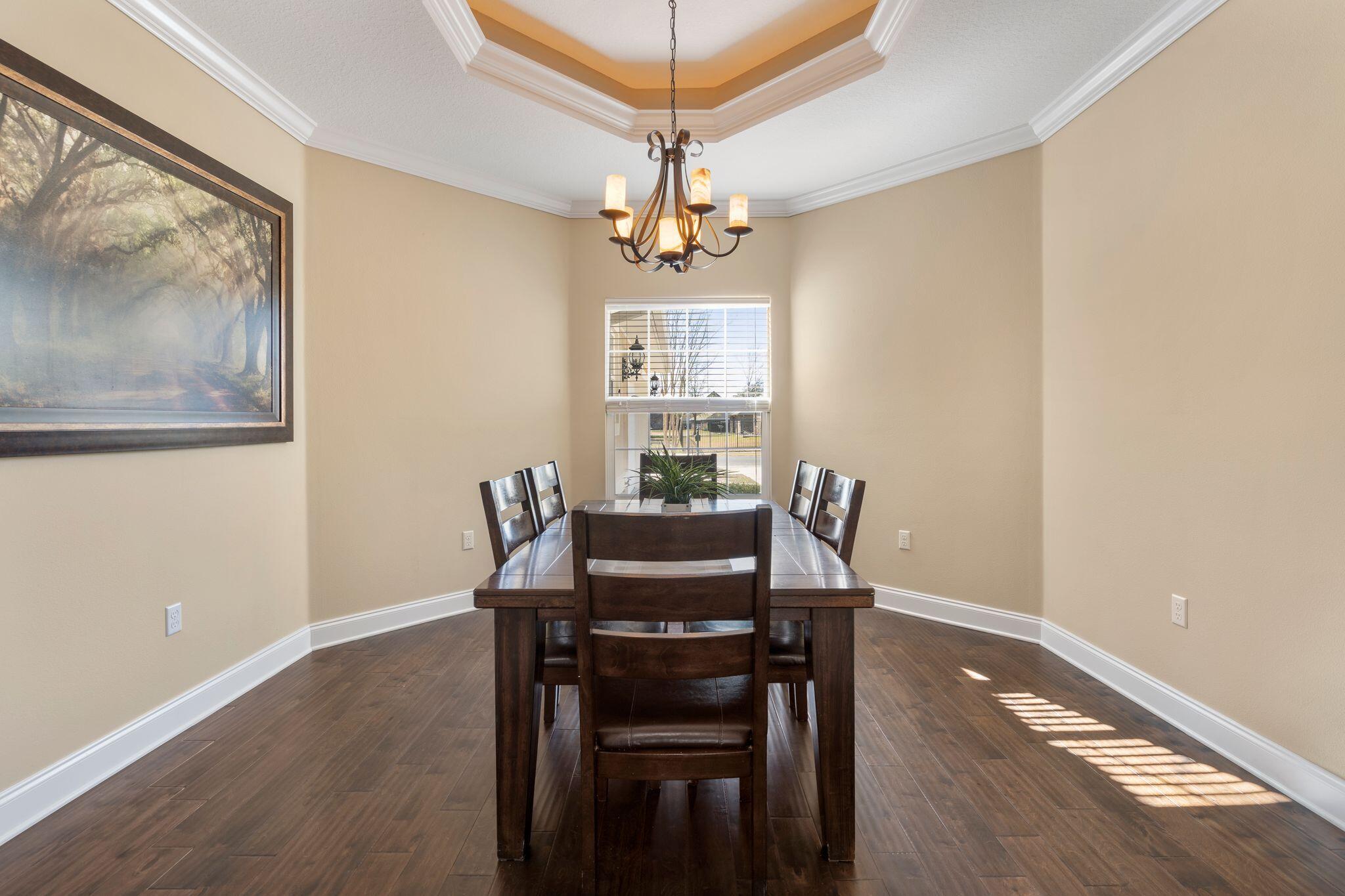 2933 Chancel Avenue Crestview, FL 32539 - Photo 4 of 44 a view of a dining room with furniture window and wooden floor