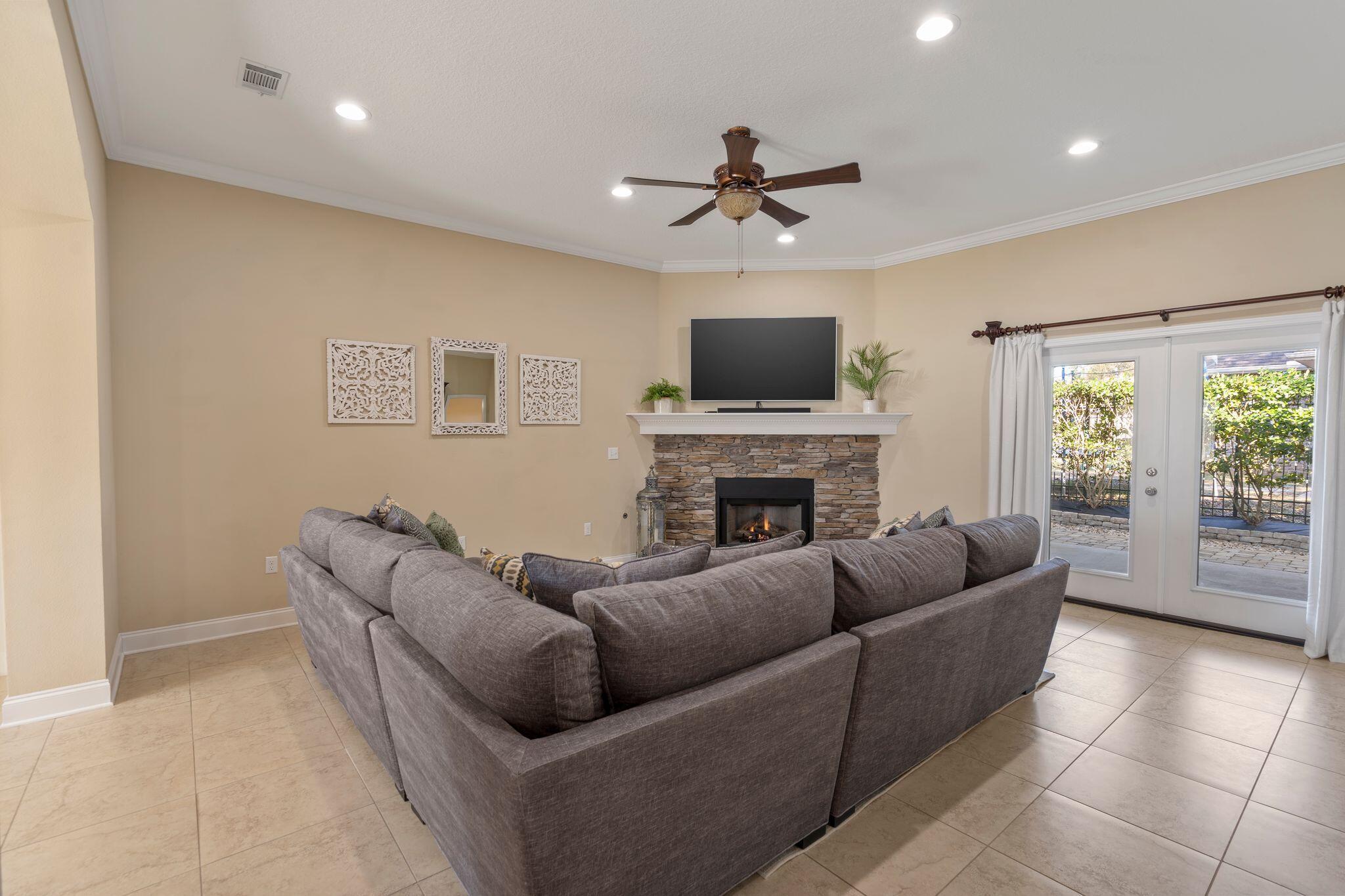 2933 Chancel Avenue Crestview, FL 32539 - Photo 7 of 44 a living room with furniture a fireplace and a flat screen tv