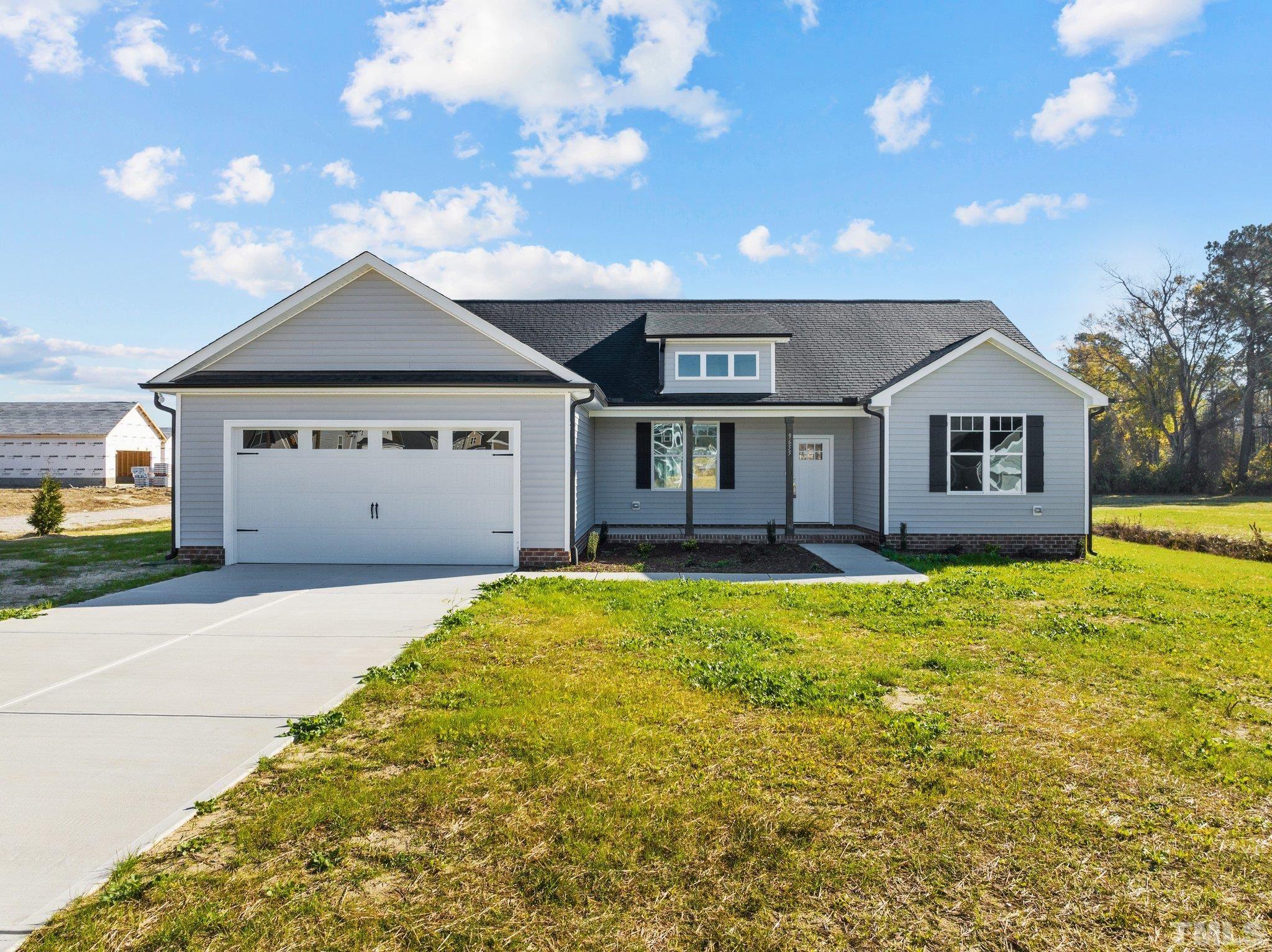9655 Chapman Road Bailey, NC 27807 - Photo 1 of 33 a front view of a house with a garden and yard