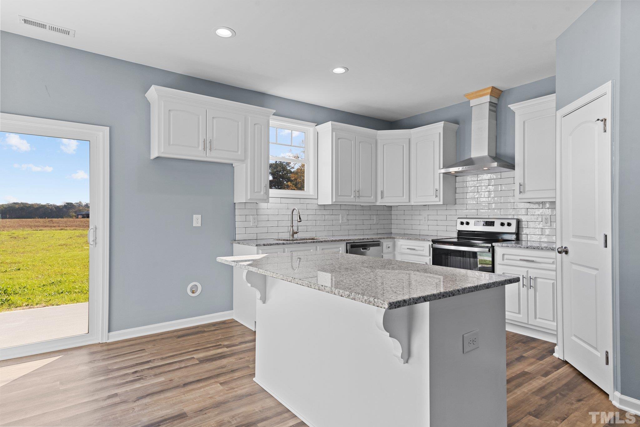 9655 Chapman Road Bailey, NC 27807 - Photo 12 of 33 a kitchen with stainless steel appliances granite countertop a sink stove and refrigerator