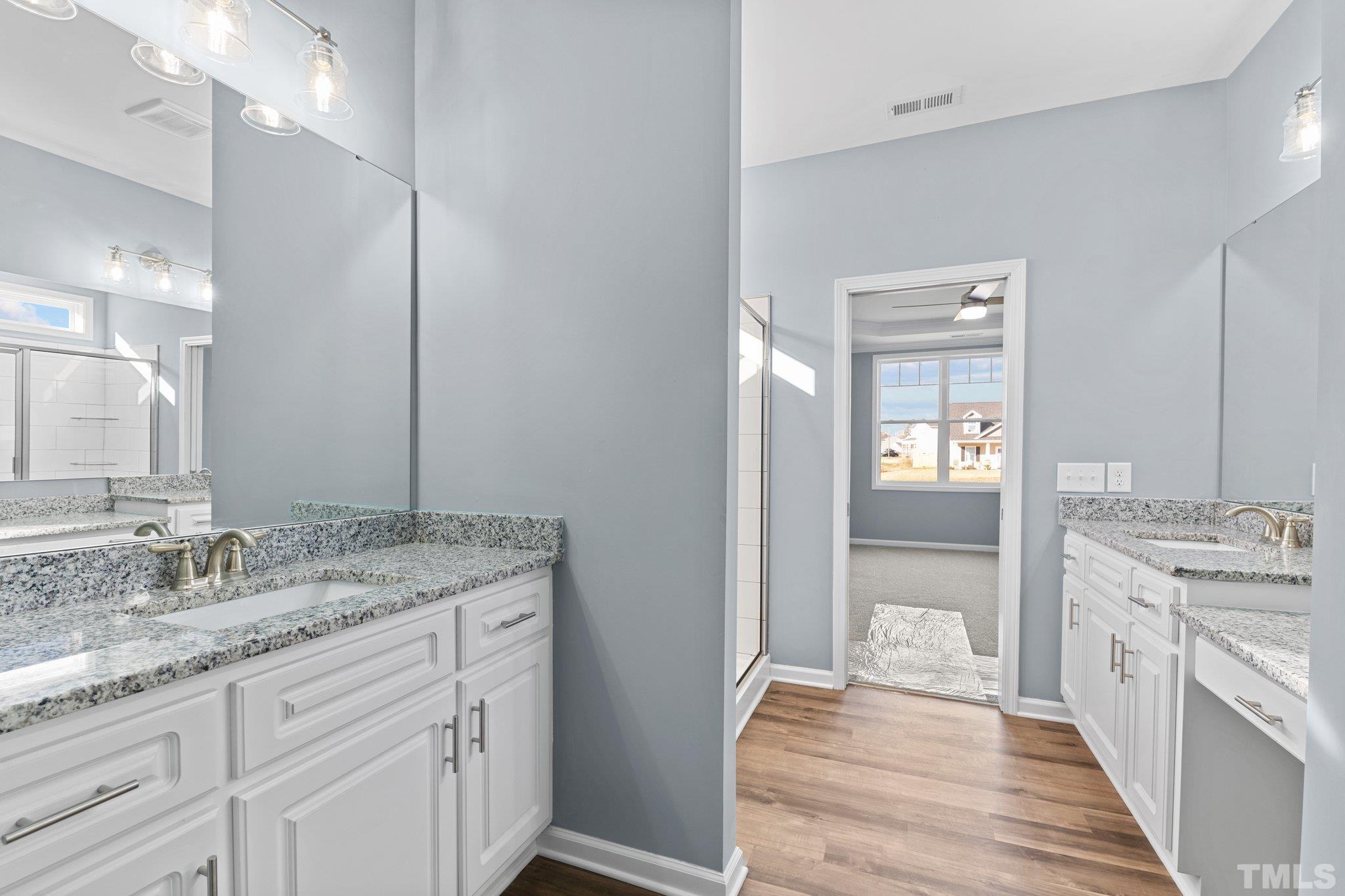 9655 Chapman Road Bailey, NC 27807 - Photo 18 of 33 a spacious bathroom with a granite countertop sink and a mirror