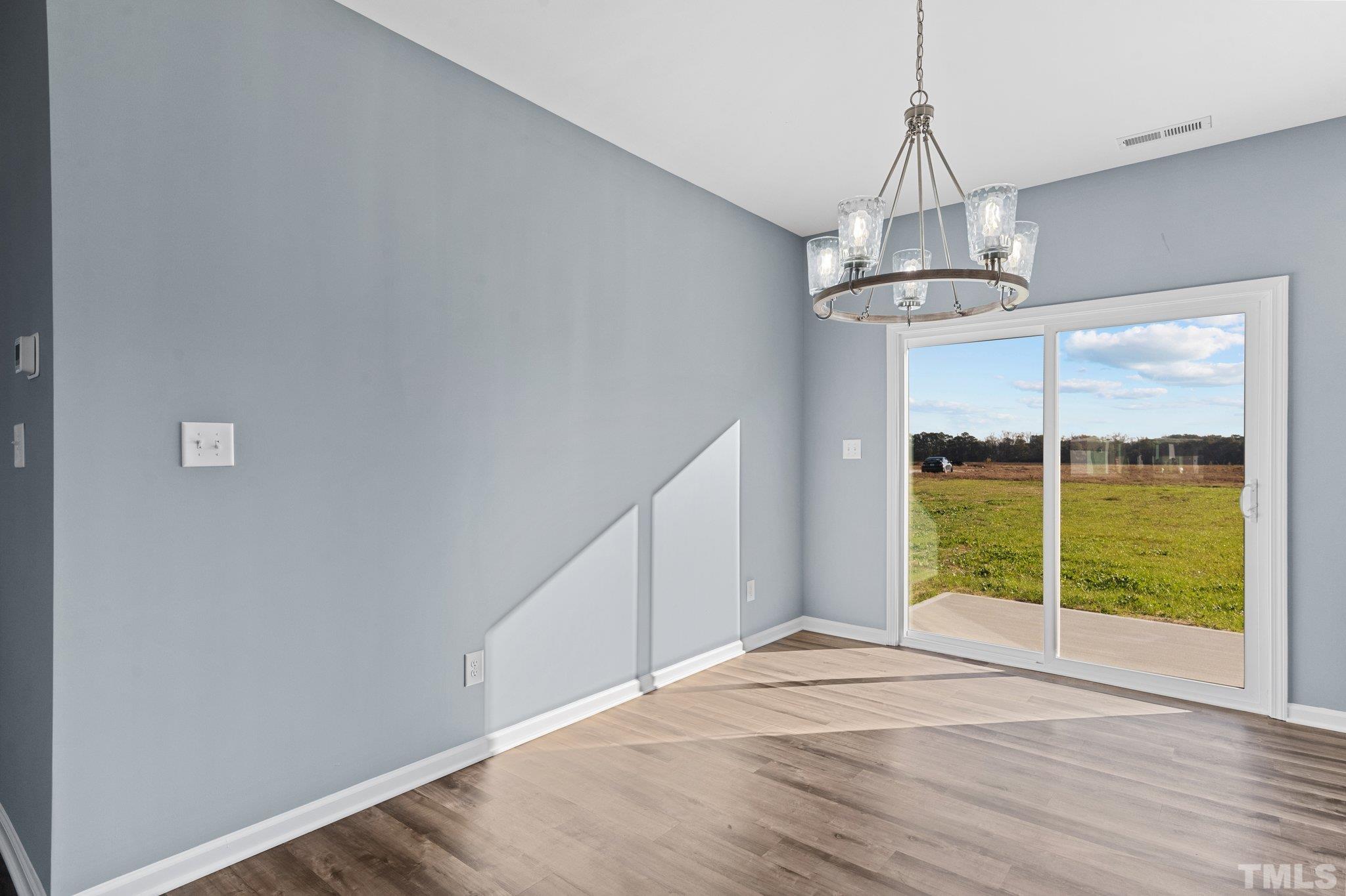 9655 Chapman Road Bailey, NC 27807 - Photo 22 of 33 a view of empty room with wooden floor and chandelier