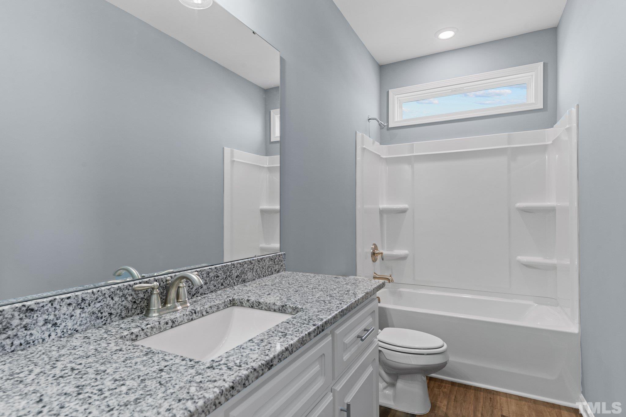 9655 Chapman Road Bailey, NC 27807 - Photo 23 of 33 a bathroom with a granite countertop sink toilet and shower
