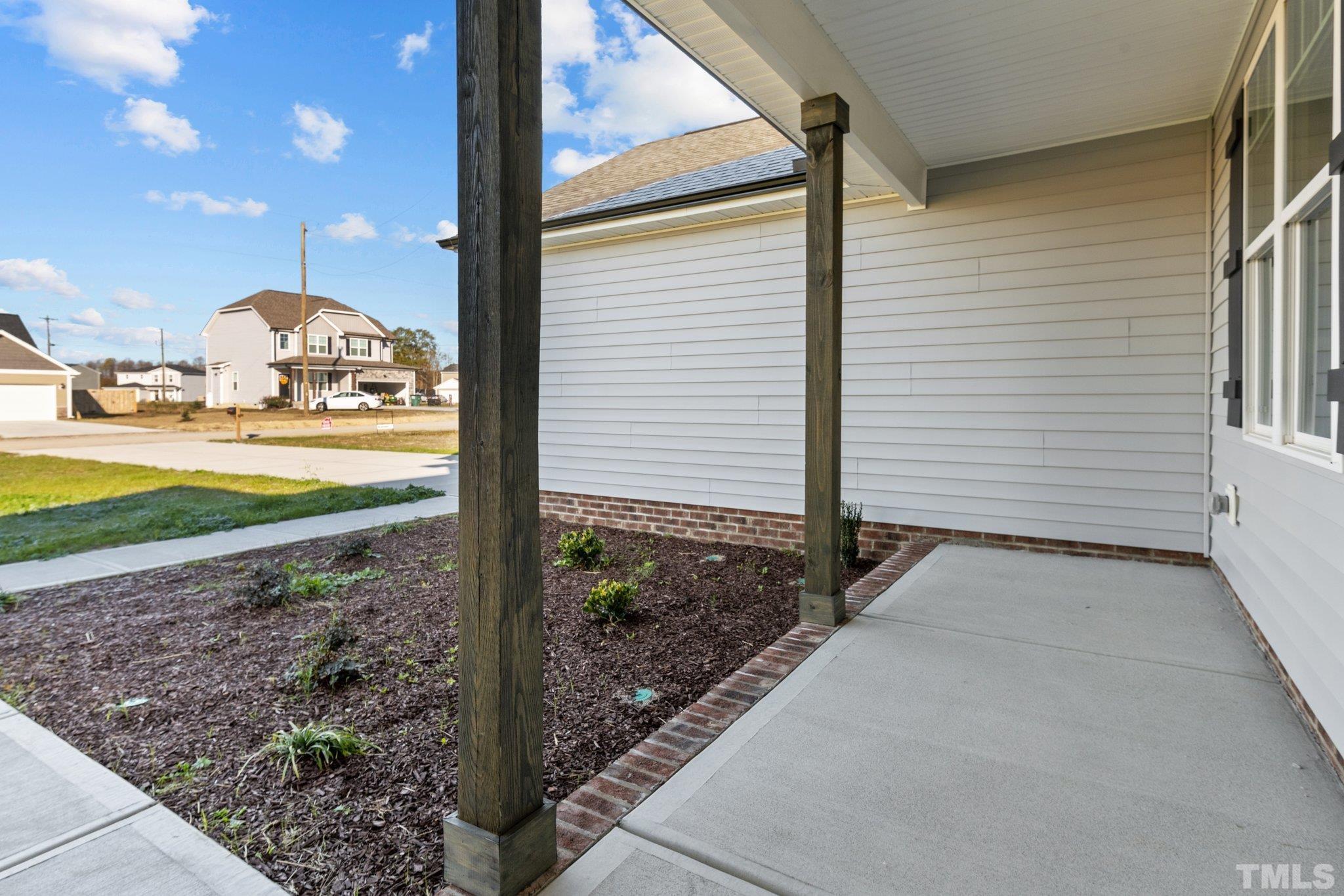 9655 Chapman Road Bailey, NC 27807 - Photo 4 of 33 a view of a porch with a floor to ceiling window and yard