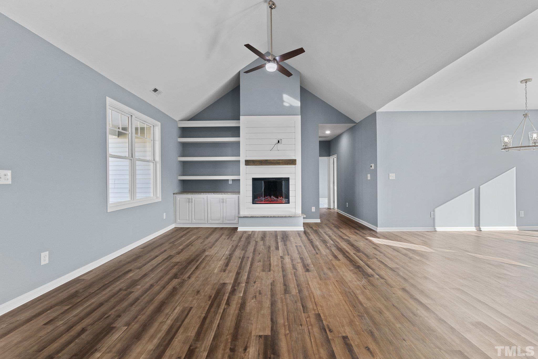 9655 Chapman Road Bailey, NC 27807 - Photo 6 of 33 a view of an empty room with a fireplace and a window