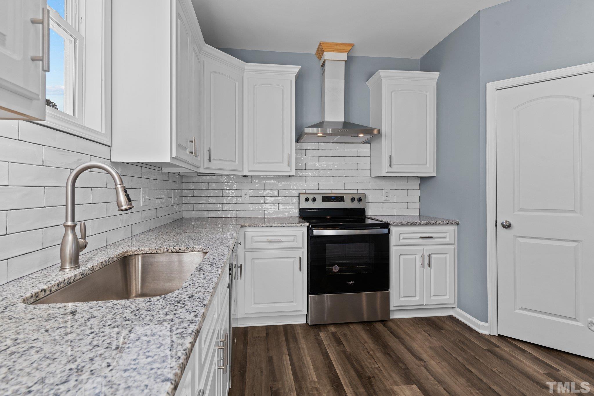 9655 Chapman Road Bailey, NC 27807 - Photo 9 of 33 a kitchen with stainless steel appliances a sink stove and cabinets