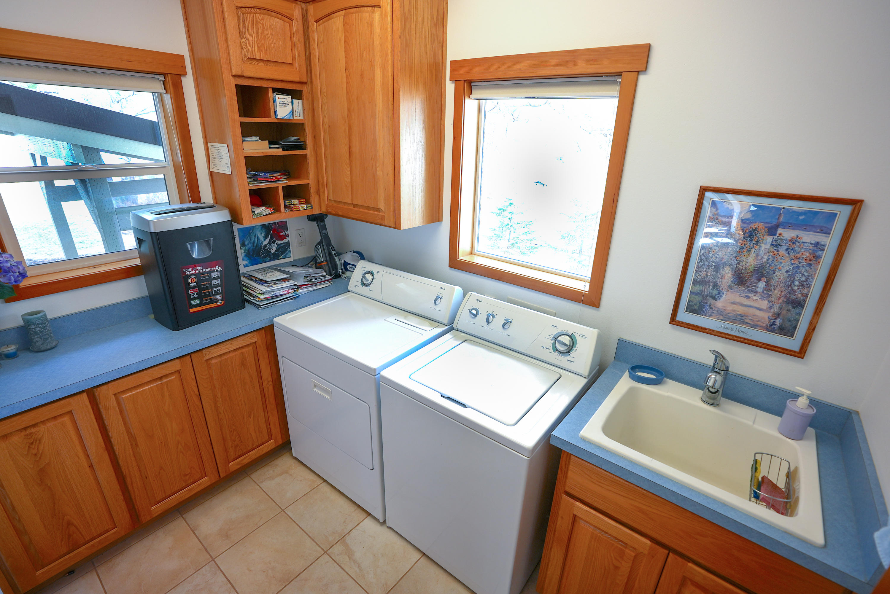 60709 Golf Village Loop Bend, OR 97702 - Photo 31 of 45 Laundry room with utility sink, cabinets and countertop for folding