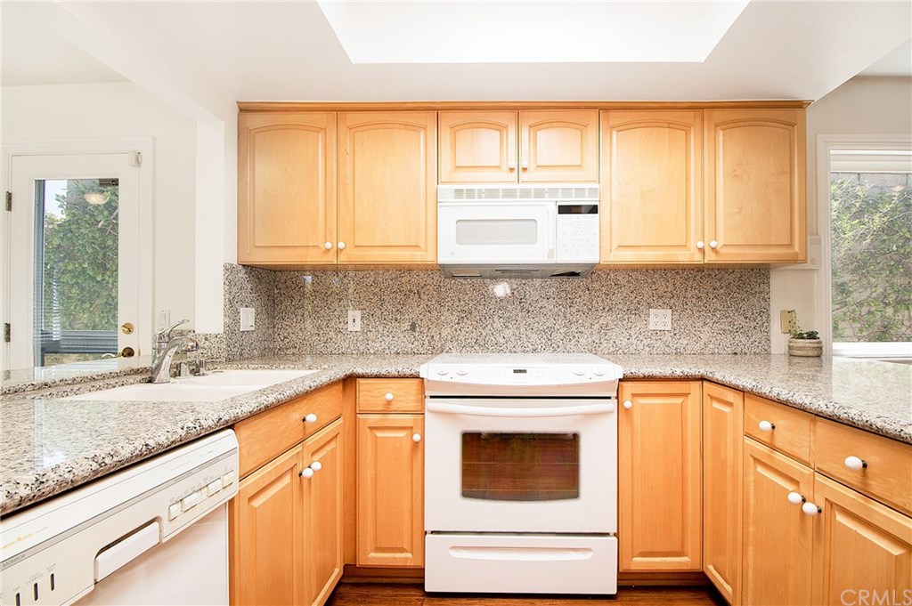 23822 Cassandra Bay Dana Point, CA 92629 - Photo 3 of 24 Kitchen with Granite Counters opens to Family Room on one side and Dining Room on the other