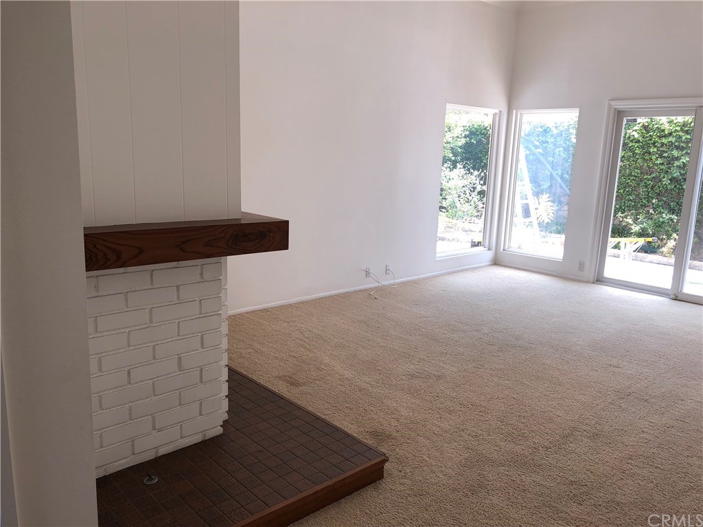 23822 Cassandra Bay Dana Point, CA 92629 - Photo 7 of 24 Living Room with Custom Doors and Fireplace