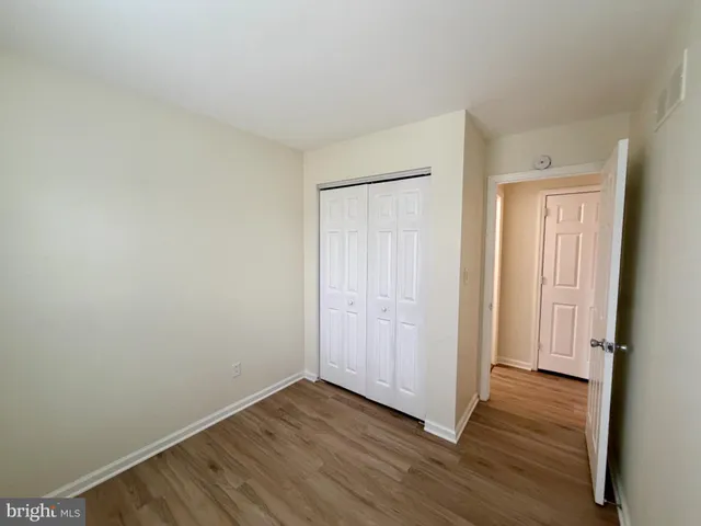a view of a room with wooden floor and staircase