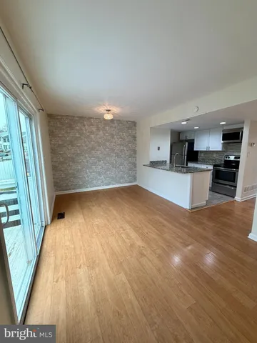 a view of kitchen and wooden floor