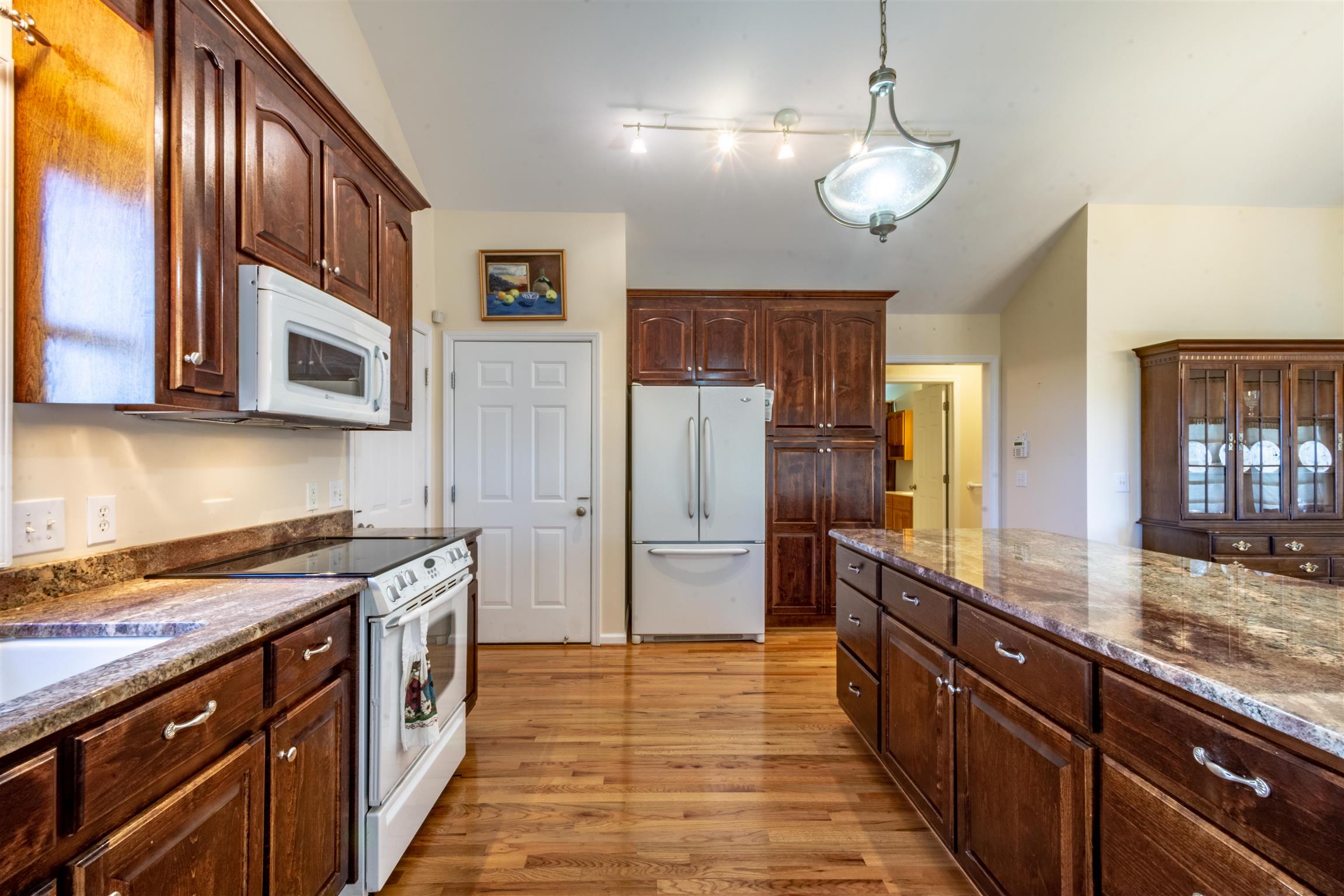 439 Agnew Road Pulaski, TN 38478 - Photo 11 of 30 a kitchen with stainless steel appliances granite countertop wooden cabinets a stove top oven a sink and dishwasher