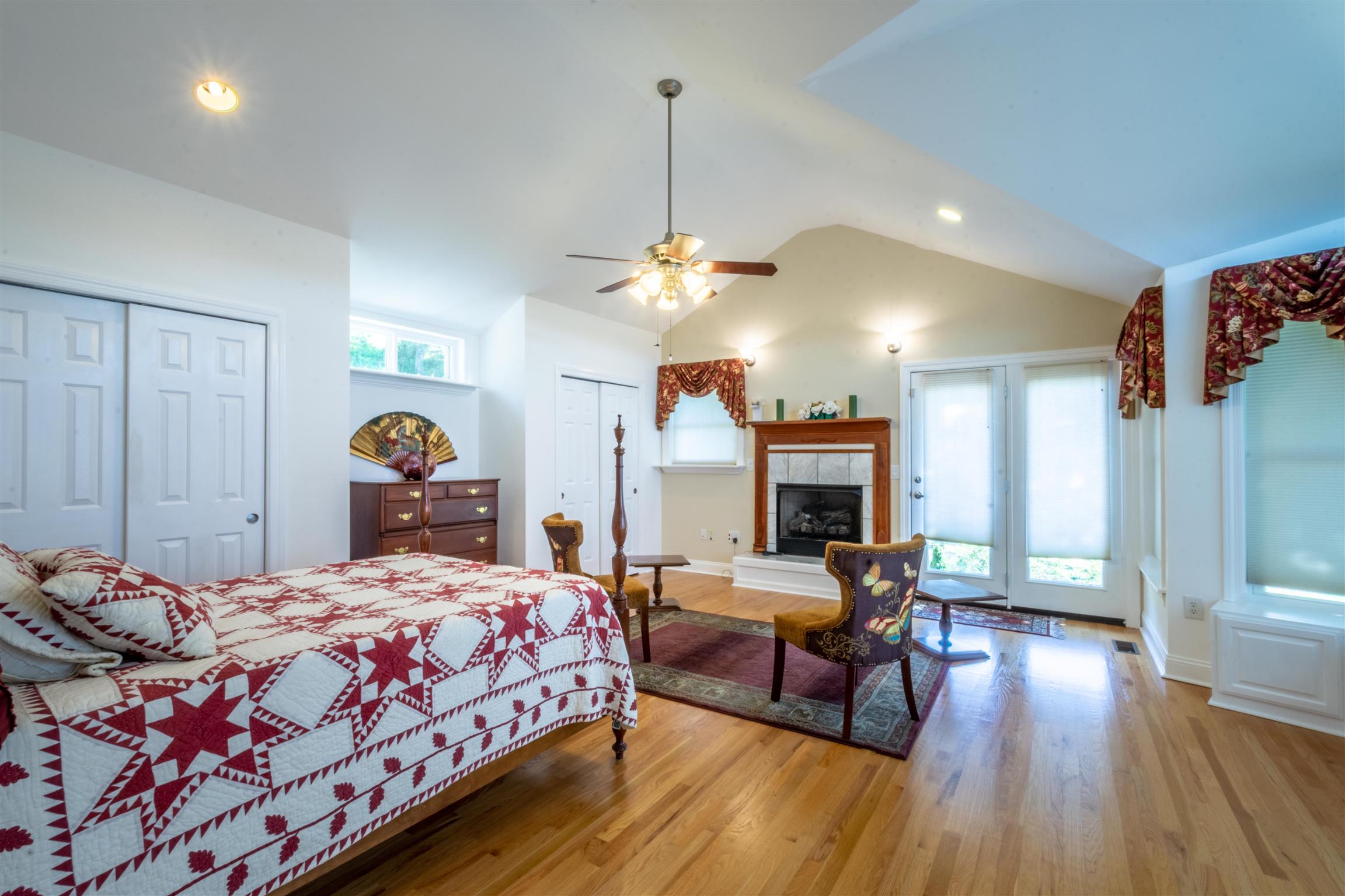 439 Agnew Road Pulaski, TN 38478 - Photo 12 of 30 a bedroom with a bed a chandelier and couch