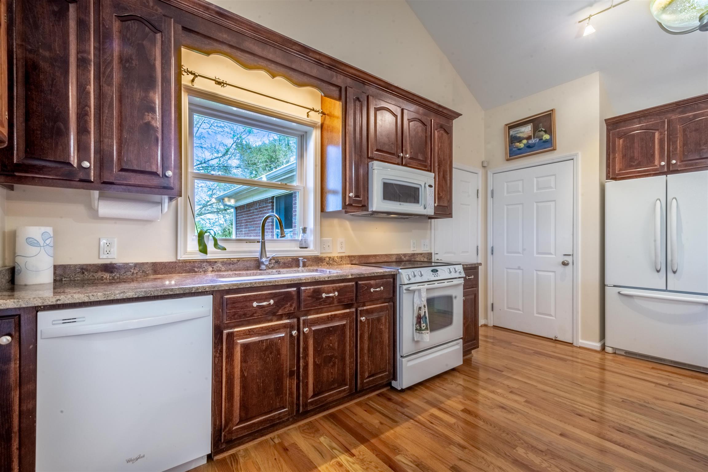 439 Agnew Road Pulaski, TN 38478 - Photo 9 of 30 a kitchen with stainless steel appliances granite countertop wooden floors and sink