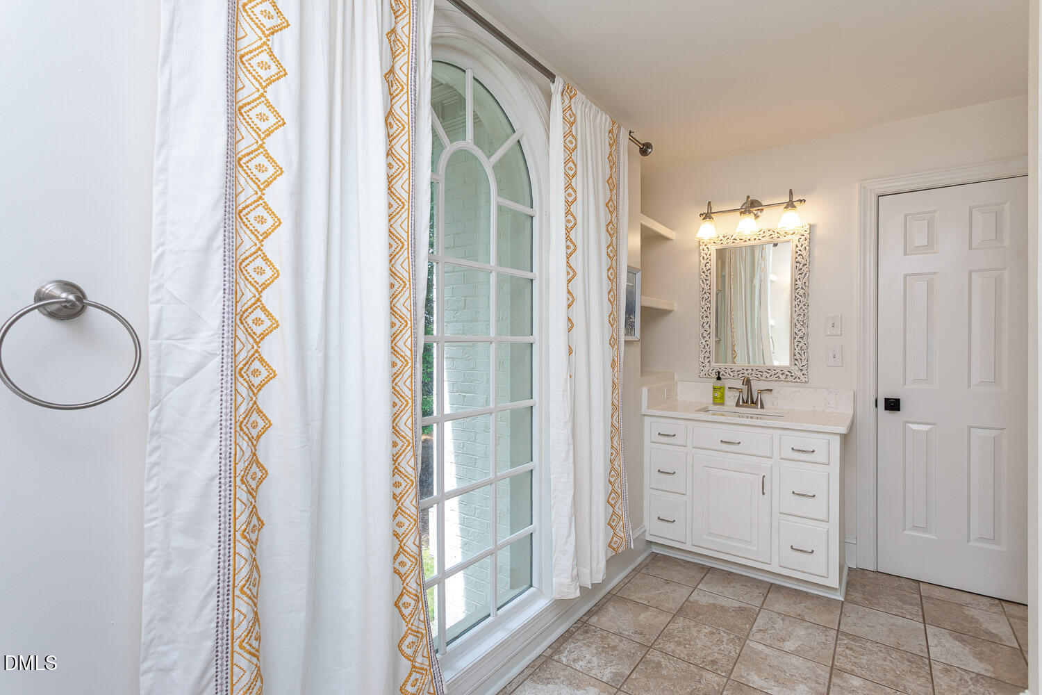 8509 Towneley Place Raleigh, NC 27615 - Photo 23 of 36 a spacious bathroom with a mirror a sink and a shower