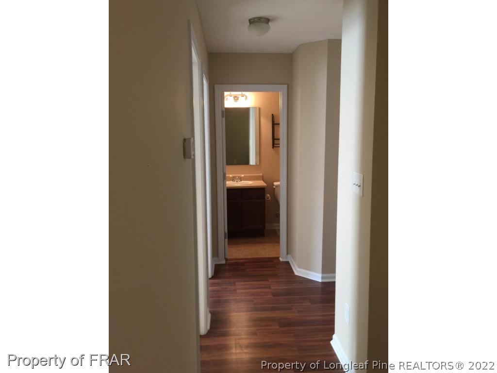 535 Cape Fear Road Raeford, NC 28376 - Photo 11 of 27 a view of a hallway with wooden floor