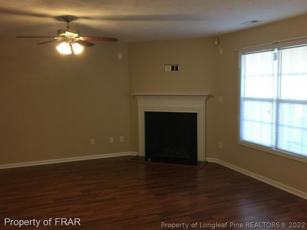 535 Cape Fear Road Raeford, NC 28376 - Photo 9 of 27 a view of a livingroom with a fireplace wooden floor and windows