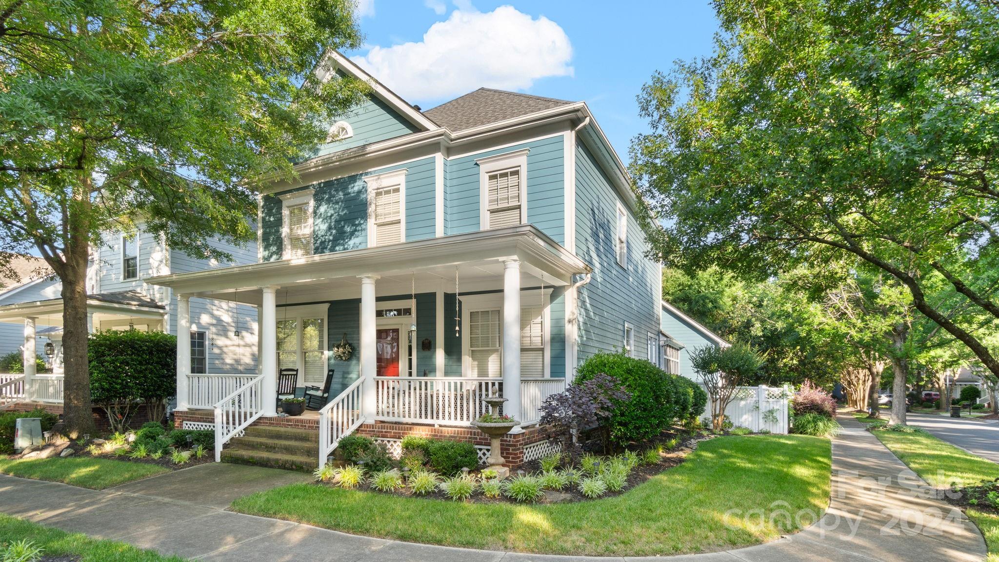 7121 Michael Scott Crossing Fort Mill, SC 29708 - Photo 1 of 46 a front view of a house with a yard and potted plants
