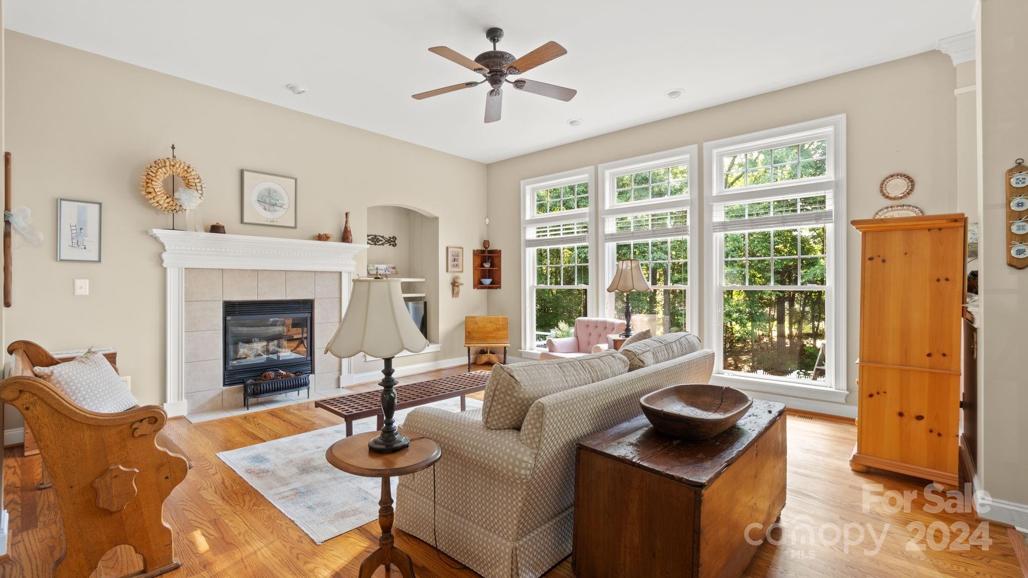 7121 Michael Scott Crossing Fort Mill, SC 29708 - Photo 12 of 46 a living room with furniture a fireplace and a large window