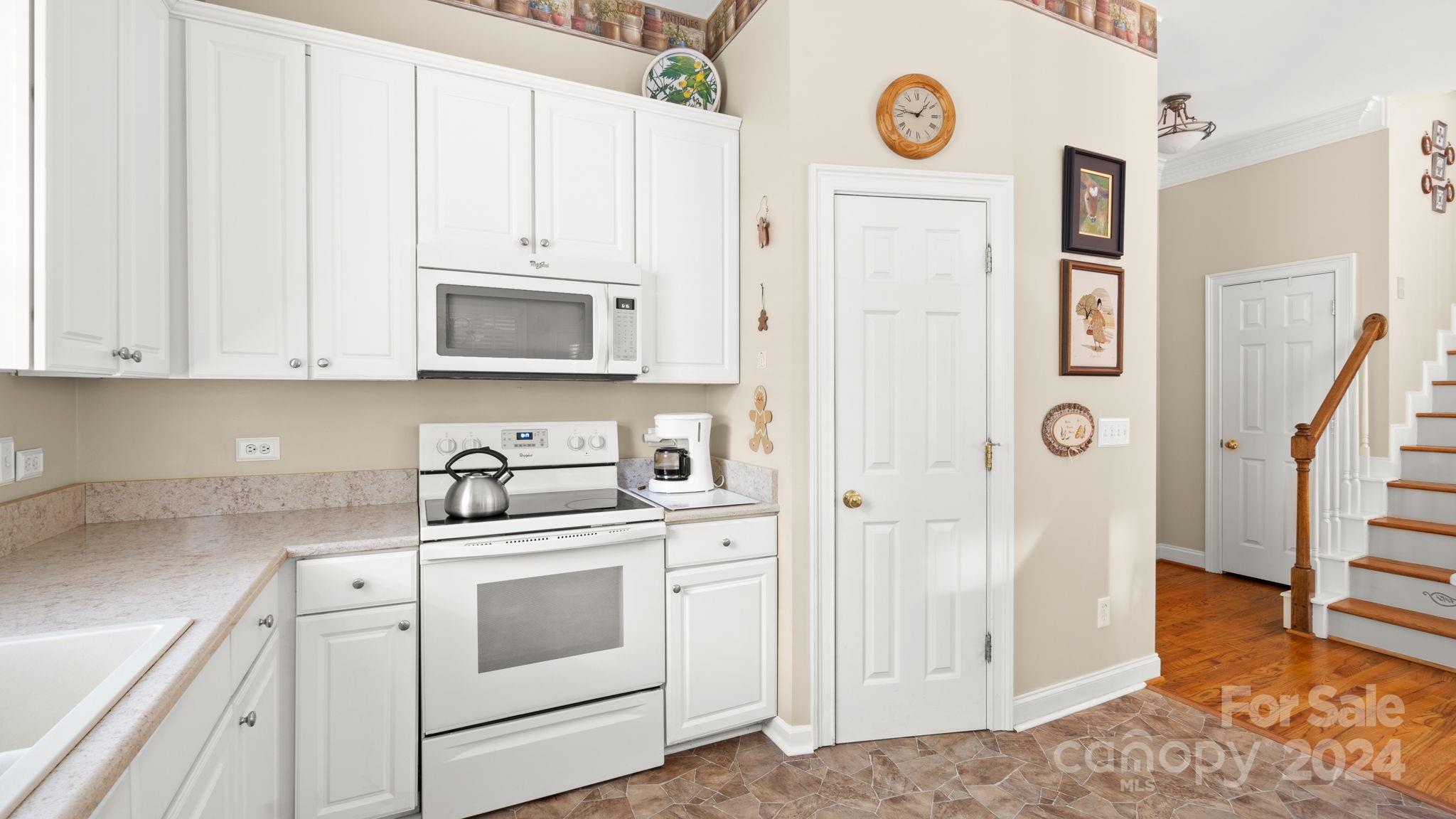 7121 Michael Scott Crossing Fort Mill, SC 29708 - Photo 17 of 46 a view of a kitchen with white cabinets and white appliances