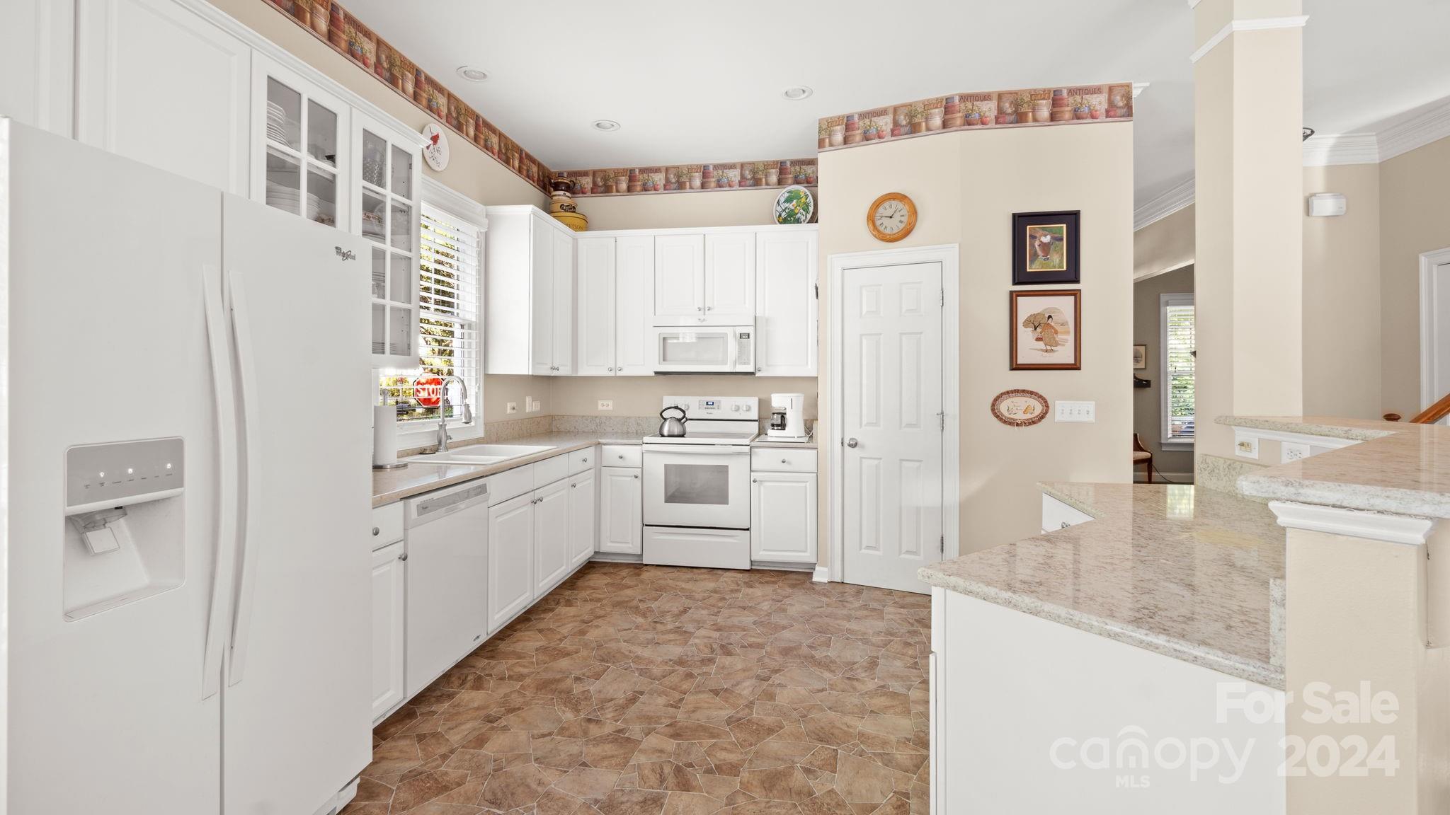 7121 Michael Scott Crossing Fort Mill, SC 29708 - Photo 18 of 46 a kitchen with a refrigerator a sink and dishwasher with white cabinets