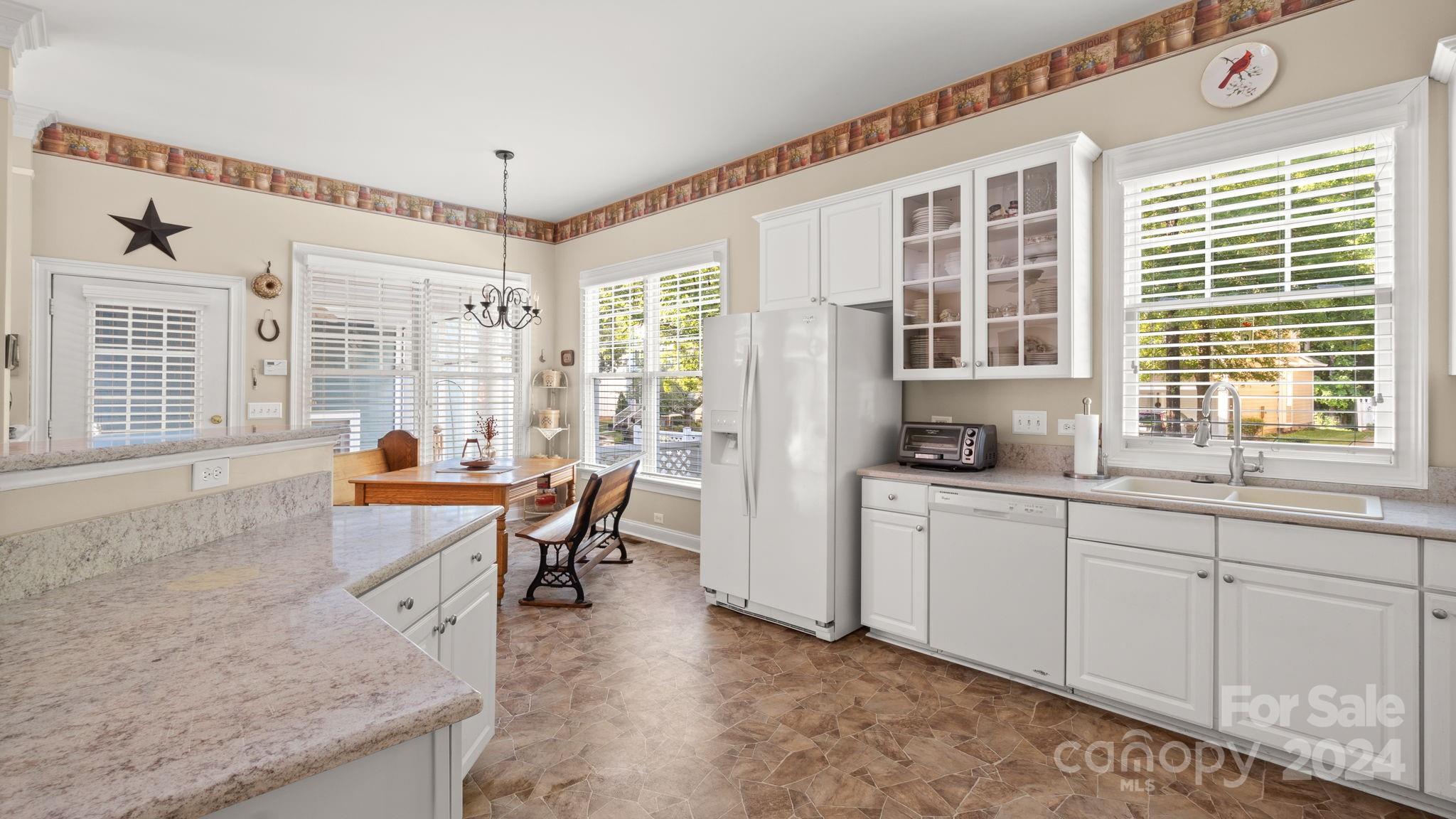 7121 Michael Scott Crossing Fort Mill, SC 29708 - Photo 20 of 46 a dining room with stainless steel appliances granite countertop furniture and a large window
