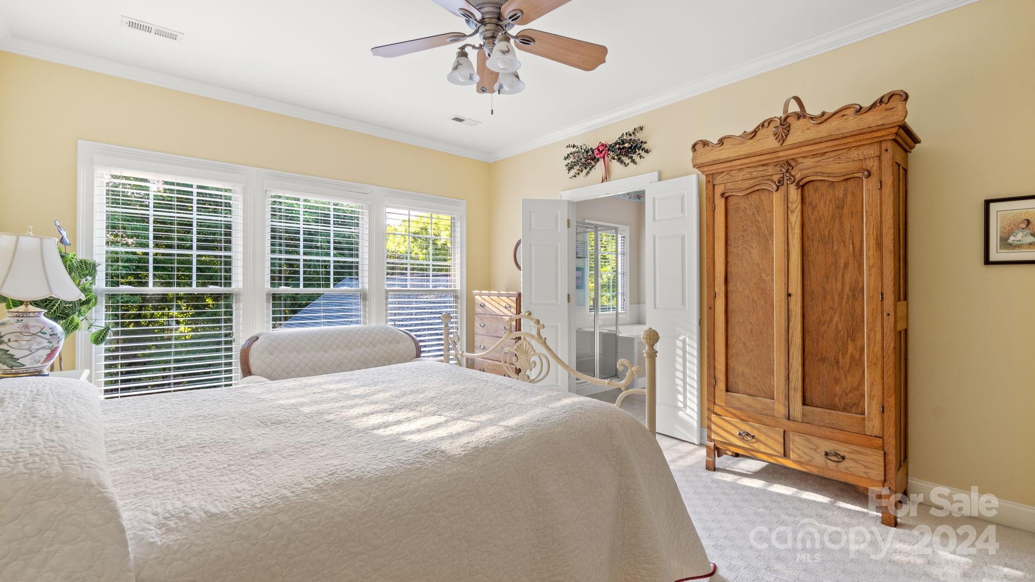 7121 Michael Scott Crossing Fort Mill, SC 29708 - Photo 25 of 46 a bedroom with a bed and a chandelier
