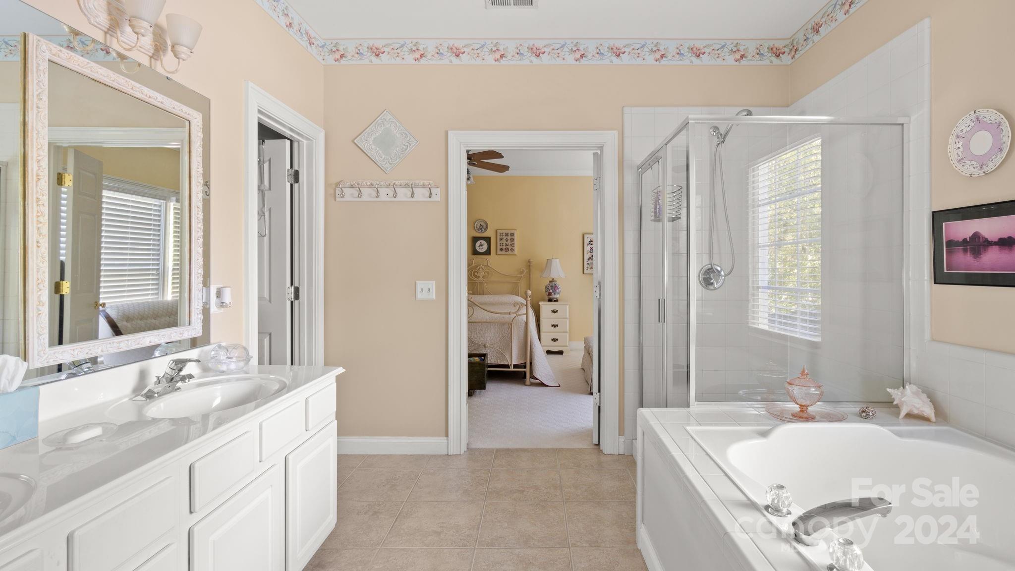 7121 Michael Scott Crossing Fort Mill, SC 29708 - Photo 28 of 46 a bathroom with a granite countertop tub sink and mirror