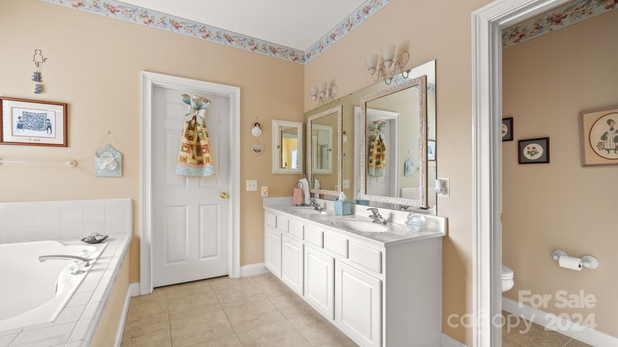 7121 Michael Scott Crossing Fort Mill, SC 29708 - Photo 29 of 46 a bathroom with a tub sink and mirror