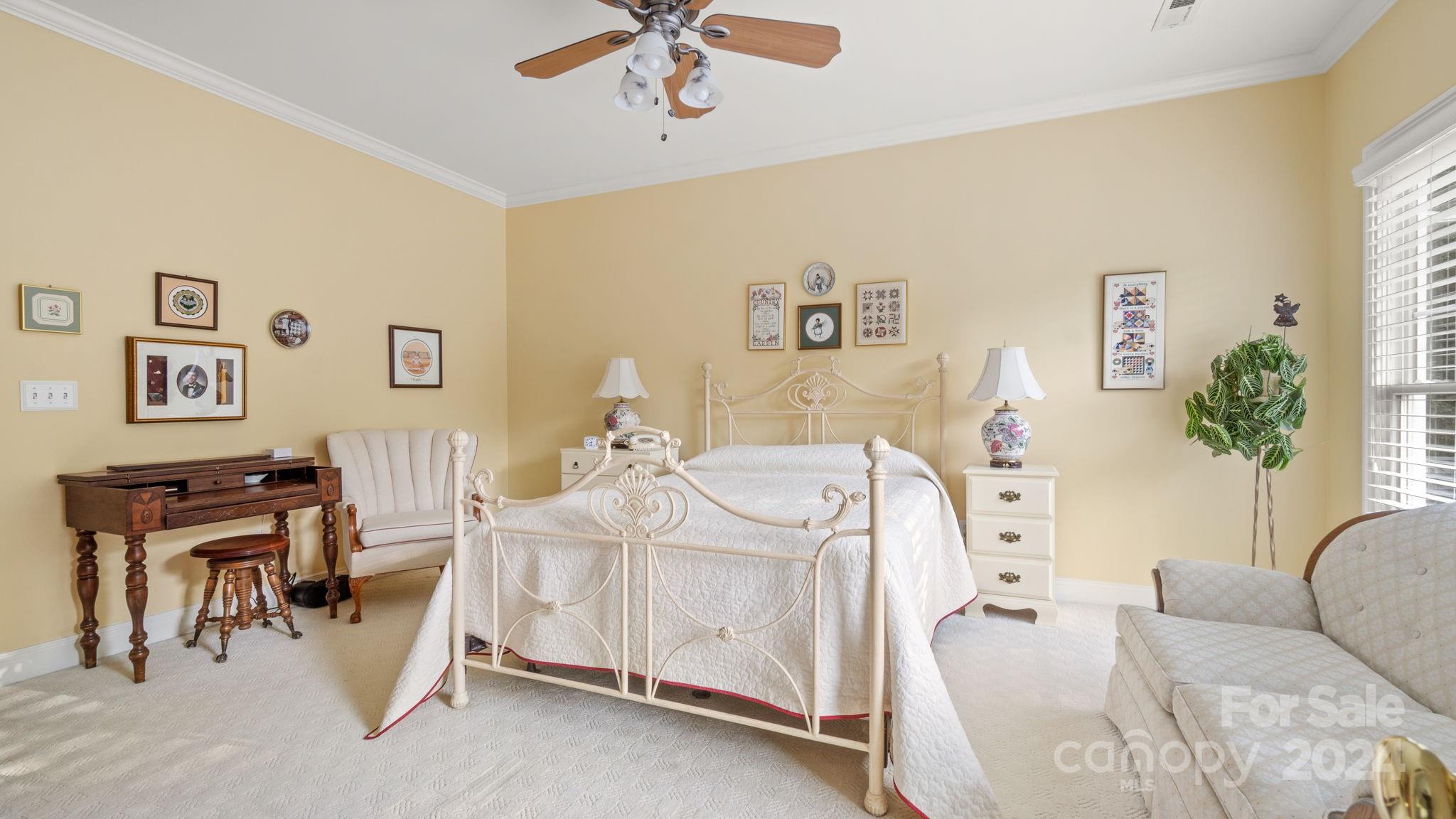 7121 Michael Scott Crossing Fort Mill, SC 29708 - Photo 30 of 46 a bedroom with furniture and a chandelier