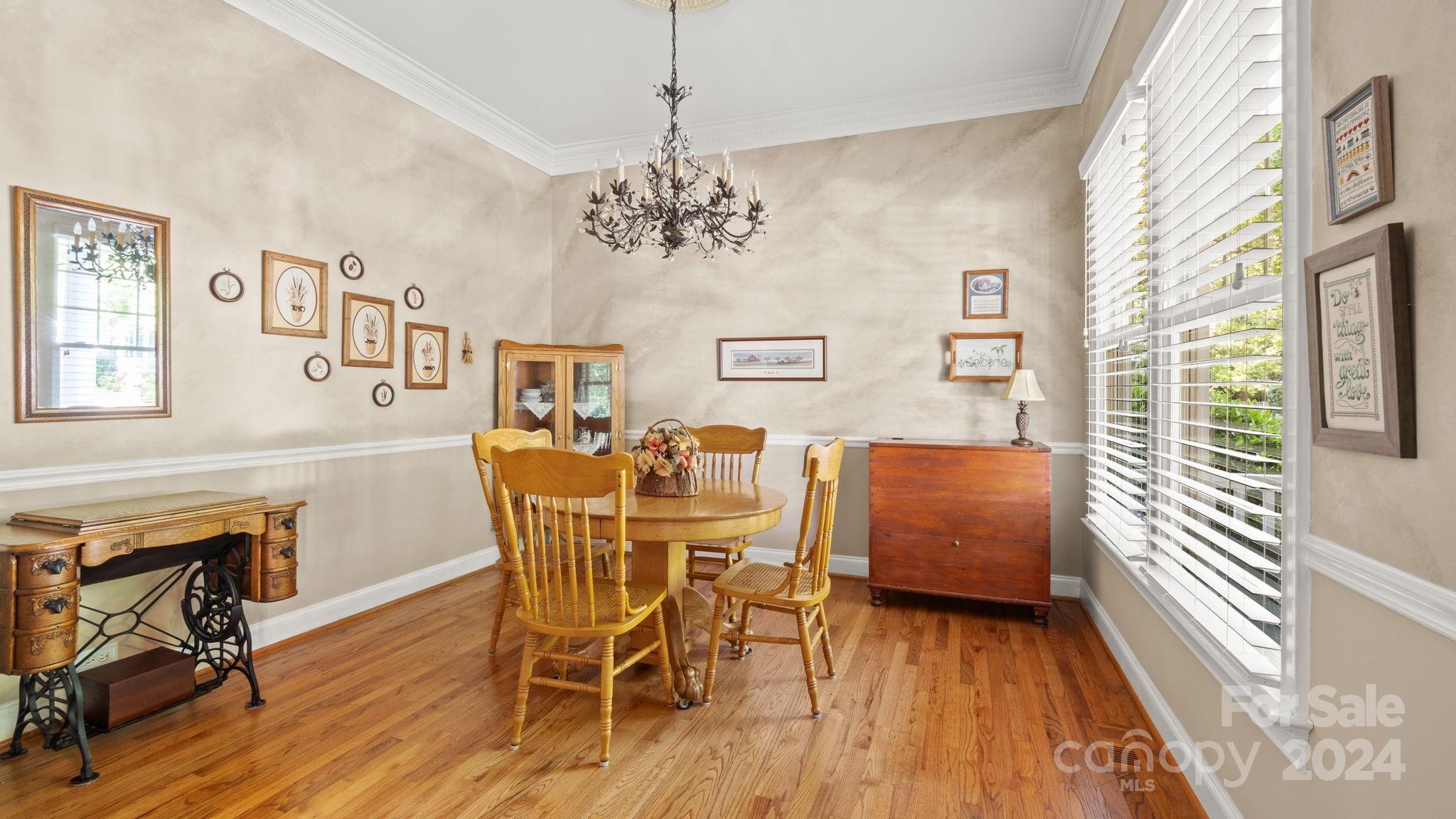 7121 Michael Scott Crossing Fort Mill, SC 29708 - Photo 9 of 46 a view of a dining room with furniture window and wooden floor