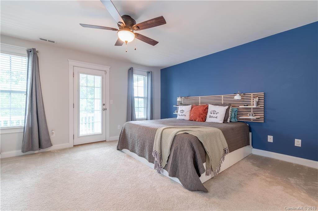 4222 Vance Road North Huntersville, NC 28078 - Photo 12 of 36 a spacious bedroom with a balcony a bed and a chandelier